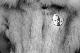 A supporter of President Vladimir Putin displayed a badge on her fur coat at a demonstration, 2007